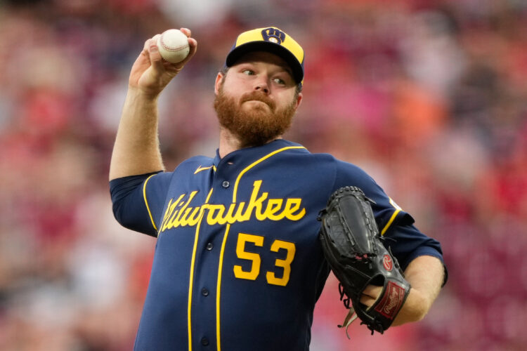 Woodruff's stellar return and Ortiz's sacrifice fly in 10th lift Brewers to 2-1 win over Reds
